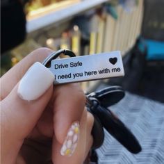 someone is holding a keychain that says drive safe, i need you here with me