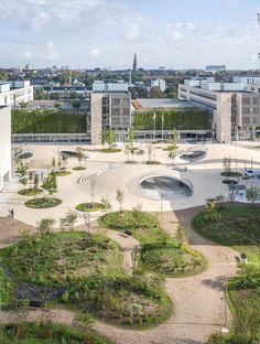 an aerial view of a large building with lots of trees in the foreground and buildings in the background