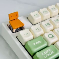 a computer keyboard with an orange block on top of it's keycaps