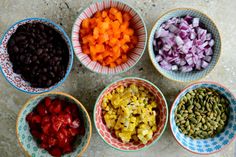 five bowls filled with different types of vegetables