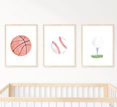 three framed sports pictures on the wall above a crib