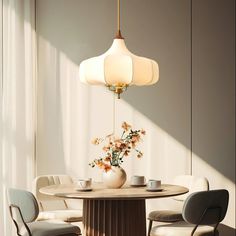 a dining room table with chairs and a vase filled with flowers sitting on top of it