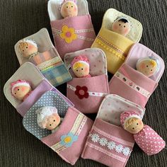 several small dolls are placed in little pink pouches