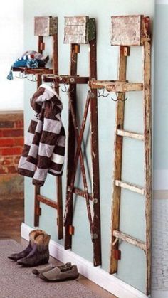 a pair of shoes sitting on the floor next to an old ladder and coat rack