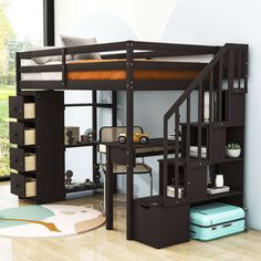 a loft bed with desk underneath it in a living room next to a large window