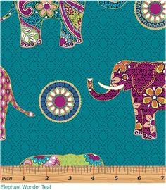 an elephant and flower pattern on a blue background with a ruler in the foreground