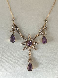 Superb attractive Victorian 9ct gold Amethyst and Pearl Necklace. Very beautiful antique necklace with four large amethyst stones surrounded by pearls and floral motifs, leaves and drops. Very pretty necklace in absolutely excellent condition Marked 9ct. Weight 6.3 grams. Length 22 Inches - 55 cms.   Please Check Sizes And Weights As JEWELLERY IMAGES ARE ENLARGED. Dark areas are reflections on the gold.  BUY WITH CONFIDENCE: I try to accurately describe my items. I never knowingly mis-sell any item, so please read the description carefully. All items are checked by a professional Jeweller for authenticity; however no certificates are provided. If for any reason the item is found not to be genuine or as described a full refund will be given. So please buy with confidence.  Your jewellery wi Antique Hallmarked Purple Necklaces, Vintage Amethyst Yellow Gold Necklace, Antique Purple Hallmarked Necklaces, Vintage Amethyst Necklace In Yellow Gold, Antique Hallmarked Purple Necklace, Antique Purple Hallmarked Necklace, Victorian Style Hallmarked Purple Necklaces, Victorian Hallmarked Purple Necklace, Layerd Necklace