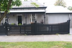 a house with a black fence in front of it