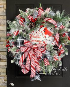 a christmas wreath is hanging on the front door