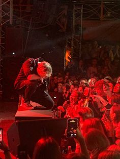 a man with red hair on stage in front of a crowd