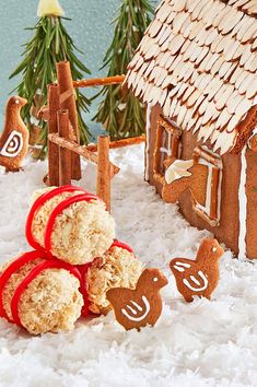 gingerbread cookies are arranged in front of a ginger house