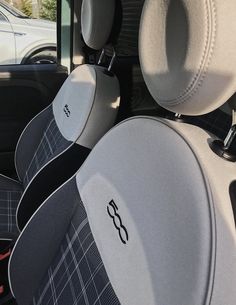 the interior of a vehicle with seats and steering wheel covers