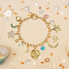 Capture the magic of summer with this Moon Star Charm Bracelet! Delicate moons and stars, featuring 18k gold-plated brass heart charm, dance alongside sparkling cubic zirconia. This simple and stylish bracelet is a reminder that wonder lives among the stars, adding a touch of celestial charm to any outfit. A shimmering reminder that we share the universe with the moon and stars, this astrology bracelet is perfect for summer nights. Layer it or wear it solo, it perfectly complements your various styles. DETAILS Plating: 18K Gold Materials: 18K Gold on Brass, Cubic Zirconia Measurements: Length: 7.48"(19cm) Pendant Size: 0.75"*0.87"(1.9cm*2.2cm) Weight: 23.6g Star Charm Bracelet, Astrology Jewelry, Moons And Stars, The Moon And Stars, Hoop Charms, Pearl Necklace Earrings, Sterling Silver Anklet, Everyday Luxury, Gold Charm Bracelet