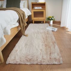 a white rug on the floor in a bedroom