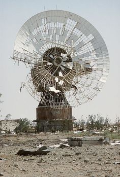 an old satellite dish sitting in the middle of nowhere