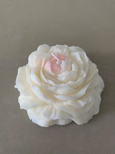 a white flower sitting on top of a table