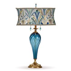 a table lamp with a blue glass base and a gold metal base, on a white background