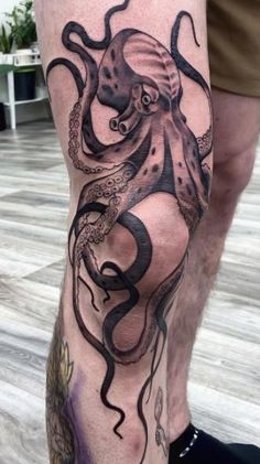 an octopus tattoo on the leg of a man