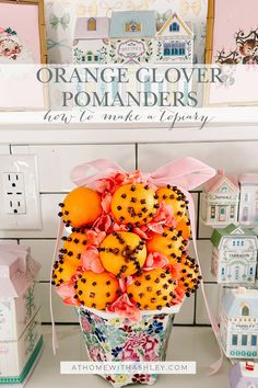 oranges are arranged in a basket on a shelf next to other boxes and decorations