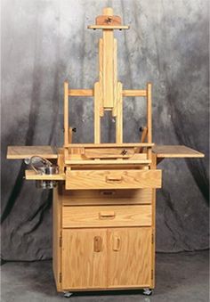 a wooden workbench sitting on top of a metal table with drawers underneath it