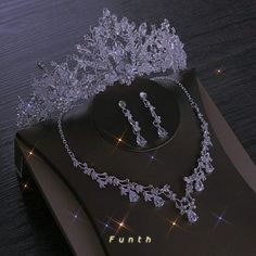 a tiara and necklace on top of a book with the word fun written below it