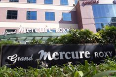 there is a large sign that says grand mercure roxy in front of the building