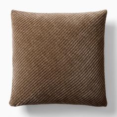 a brown pillow sitting on top of a white wall