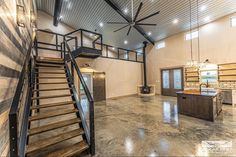 a large open floor plan with stairs leading up to the second story