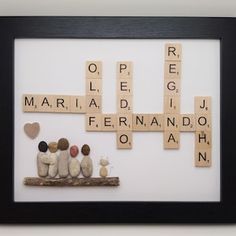 scrabbles and rocks are arranged in a black frame