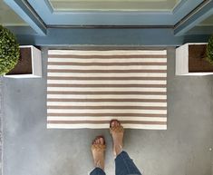 a person standing in front of a rug on the floor