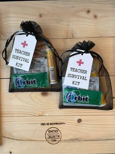 two bags with teacher survival kits on top of a wooden table next to a bottle of toothpaste