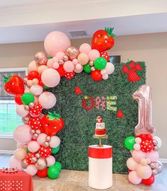 the balloon arch is decorated with red, white and green balloons