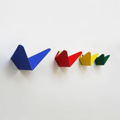 three different colored pieces of paper on a white surface with one arrow pointing to the left