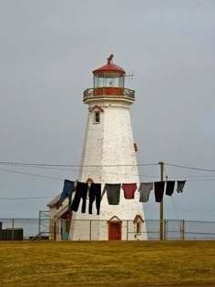 clothes hanging out to dry in front of a lighthouse