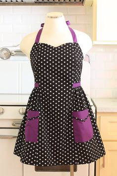 a woman's apron on a mannequin in front of a kitchen stove