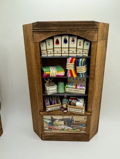 a wooden shelf with many different items on it and two small boxes in the bottom