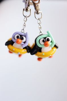 two small penguin key chains attached to each other