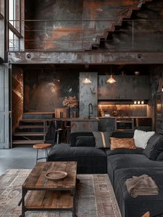 a living room filled with furniture next to a stair case in a loft type building