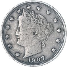 an old silver coin with stars on the side and a woman's head in profile