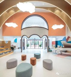 the inside of a building with several circular seating areas