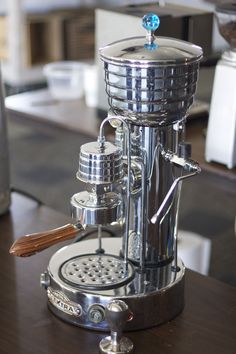 an espresso machine sitting on top of a wooden table