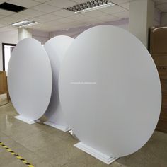 two large white round objects in an empty room