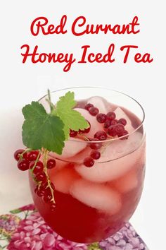 red curran honey iced tea in a glass with ice and garnish on the rim