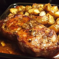 some meat and potatoes in a pan on the stove