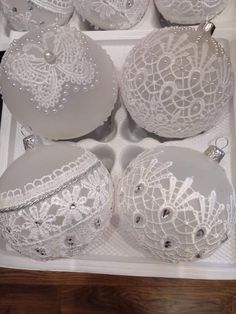 some white ornaments in a box on a table