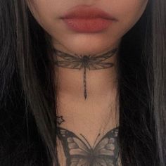 a woman with a butterfly tattoo on her neck