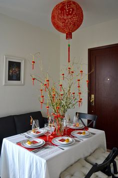 the table is set with plates and place settings for two people to eat dinner together