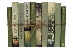 a stack of books tied up to each other with a string on the top and bottom