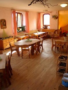 a dining room filled with wooden tables and chairs