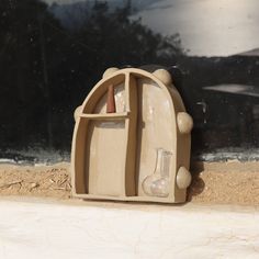 a small plastic toaster sitting on top of a window sill